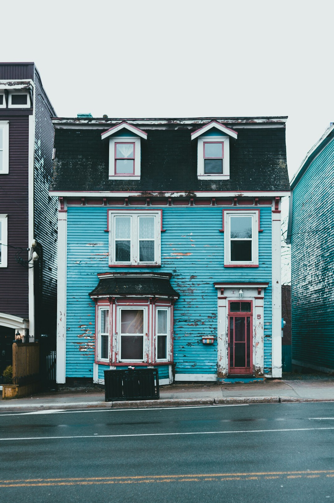 Row of colourful rowhouses on a Canadian city street