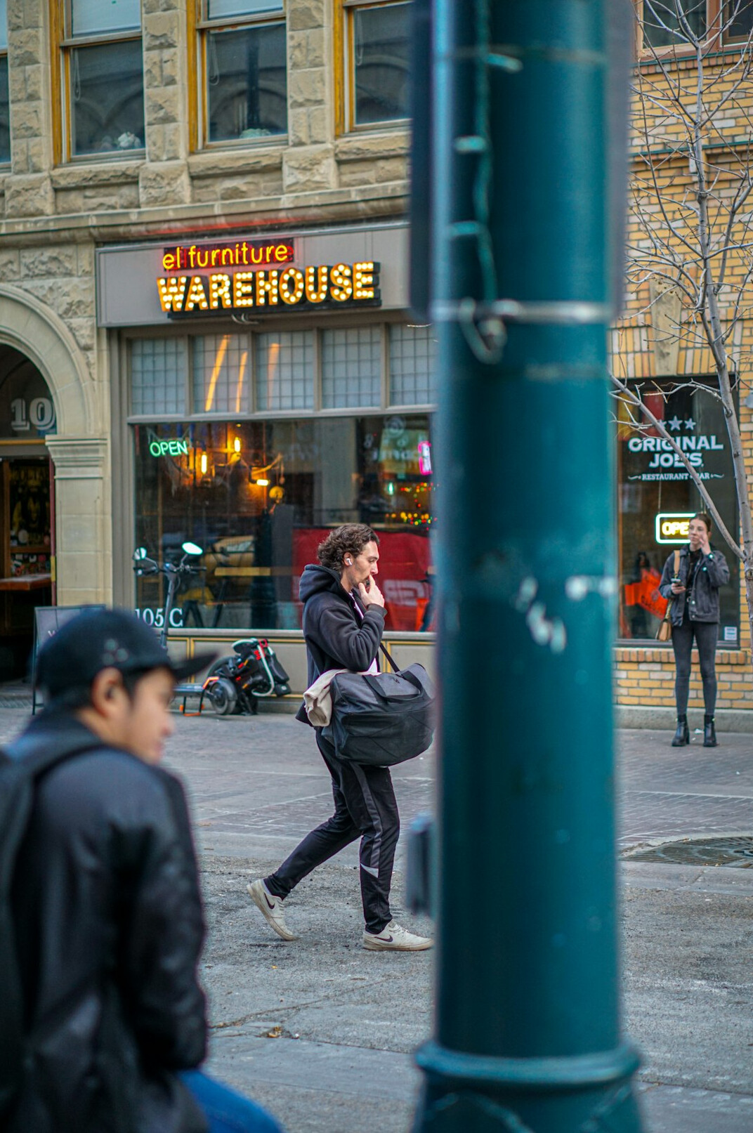 Documentary photographer taking a portrait of a man on a city street